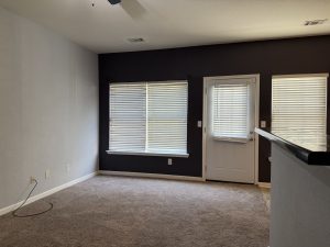Breakfast bar featuring a blue accent wall with door and windows to back yard in Decatur townhome for rent