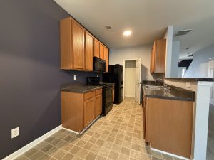 Kitchen with black appliances in Decatur townhome for rent